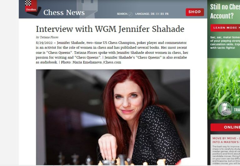 A screenshot of the interview with Jennifer Shahade. On the picture below the introduction we see Jennifer Shahade with red hair, sitting behind a chess board wearing a black blouse.